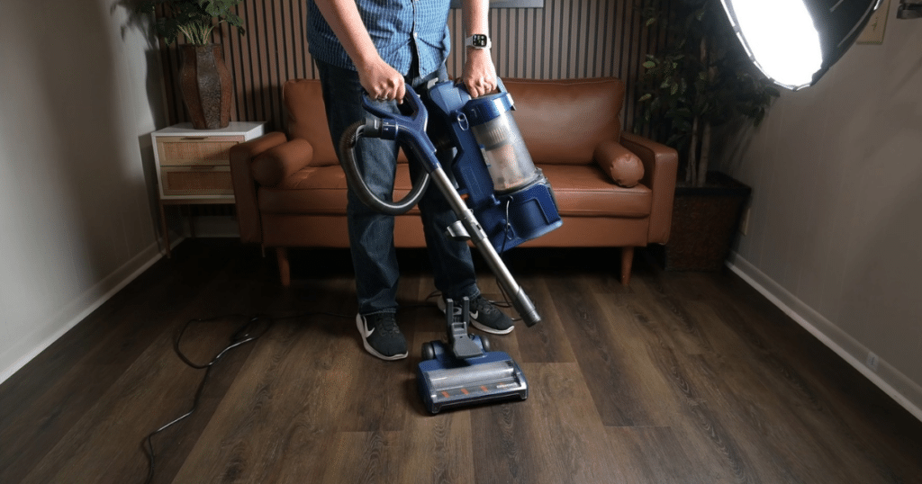 Bissell Pet Hair Eraser DualBrush 42943 with Lift-Off pod detached for above-floor cleaning, demonstrating portable cleaning capability and included hose and wand system.