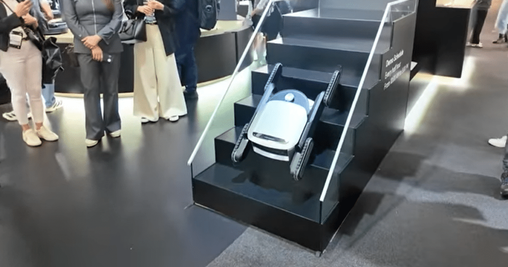 Dreame Cyber X stair-climbing robot module descending a demonstration staircase at IFA 2025 using its quad-track mobility system.
