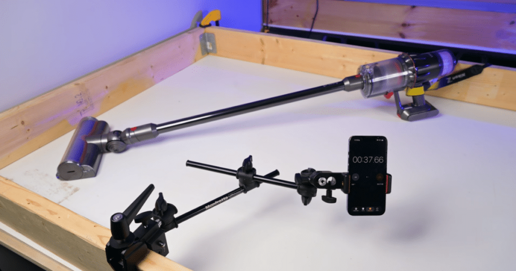 Dyson V9 Motorbar Battery Life Testing | Vacuum Wars Dyson V9 Motorbar undergoing battery runtime testing with the floorhead attached and a timer tracking the test duration.