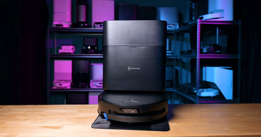 ECOVACS T80s Omni hero | Vacuum Wars ECOVACS Deebot T80s Omni robot vacuum and multifunction docking station on a tabletop in the Vacuum Wars test lab, showcasing the complete robot vacuum and mop system.