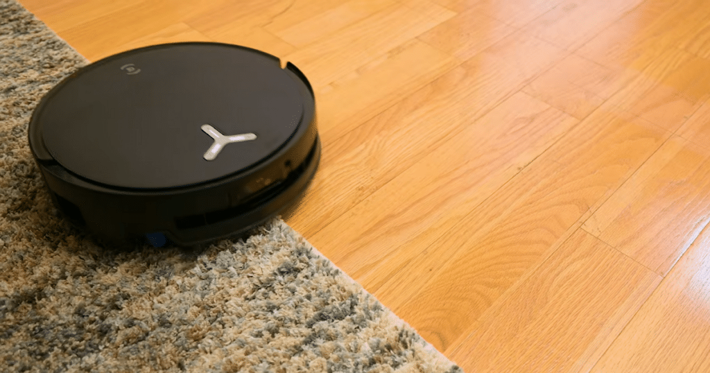 ECOVACS T80s Omni mixed floor | Vacuum Wars ECOVACS Deebot T80s Omni robot vacuum transitioning between hardwood flooring and carpet, demonstrating automatic mop lifting for mixed-surface cleaning and carpet protection.