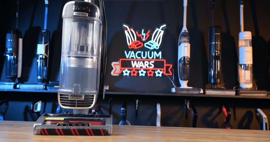 The Shark Performance Powered Lift-Away UV2500 positioned before the Vacuum Wars sign at the Vacuum Wars studio.