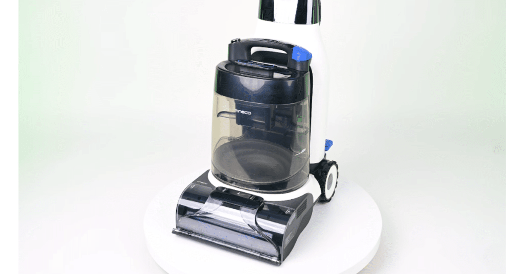 Tineco Carpet ONE Cruiser Carpet Cleaner at the Vacuum Wars Studio | Vacuum Wars Tineco Carpet ONE Cruiser carpet cleaner shown in the Vacuum Wars studio, with the front cleaning head, recovery tank, and upright handle visible.