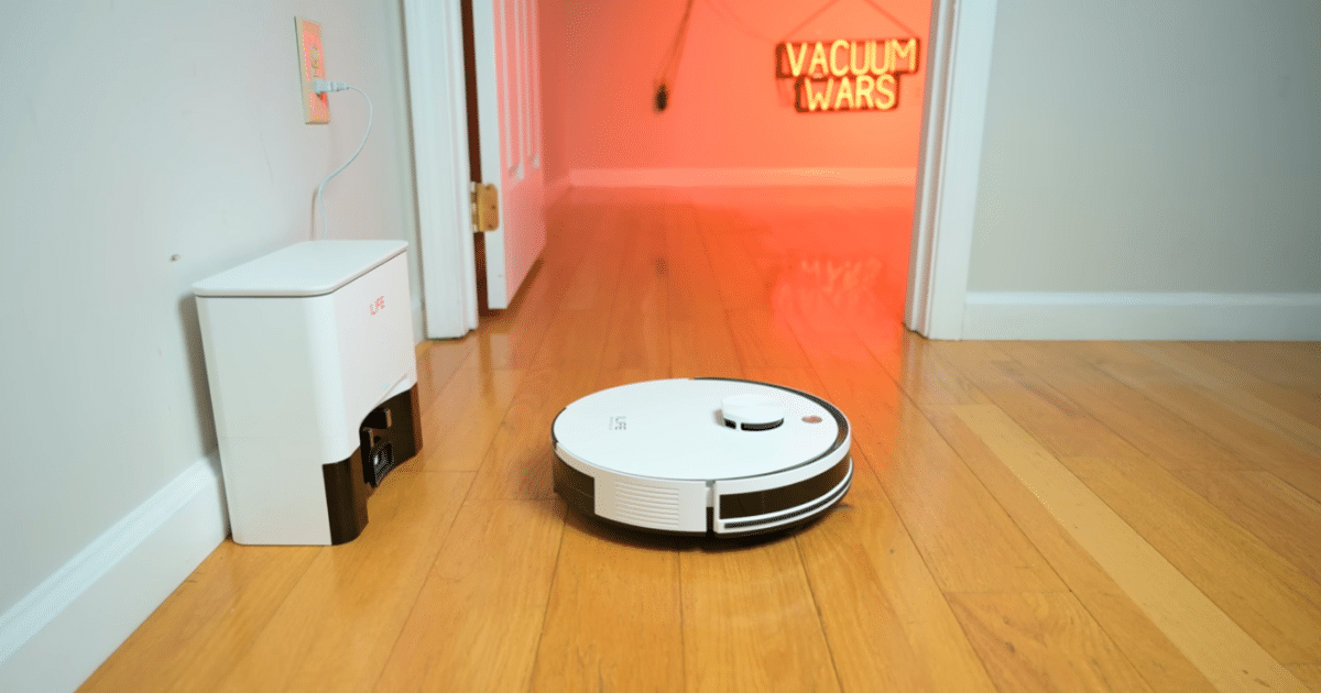 The iLife A30 Pro robot vacuum docked beside its auto-empty base station on a hardwood floor.