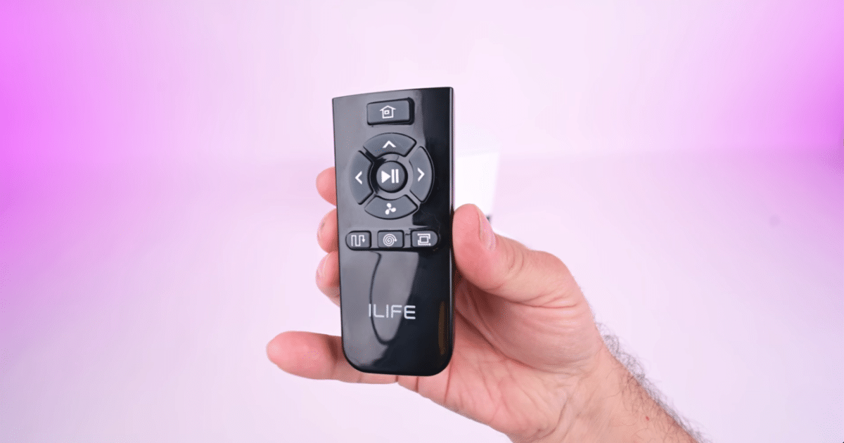 Hand holding the iLife A30 Pro remote control, which provides access to cleaning modes, suction settings, navigation controls, and docking functions.