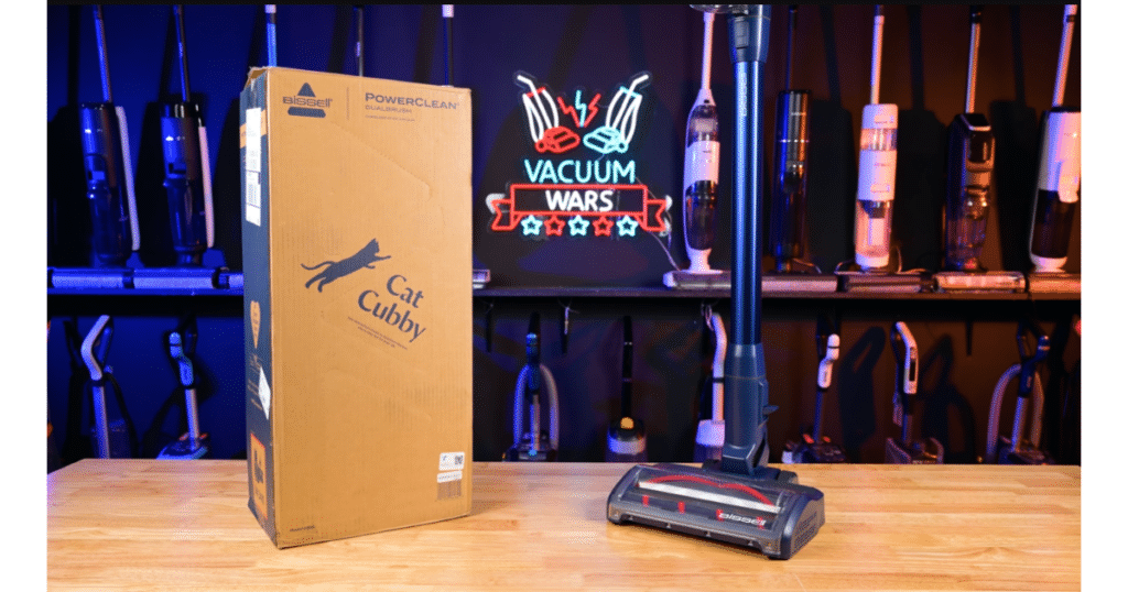 Bissell PowerClean DualBrush Cordless Vacuum Test Review Hero at Vacuum Wars | Vacuum Wars Bissell PowerClean DualBrush cordless vacuum displayed beside its product box in the Vacuum Wars studio.