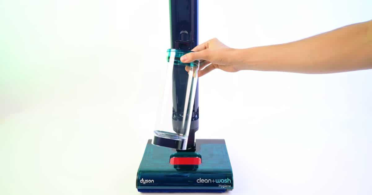| Vacuum Wars Dyson Clean+Wash Hygiene clean water tank being removed from the upright hard floor cleaner.
