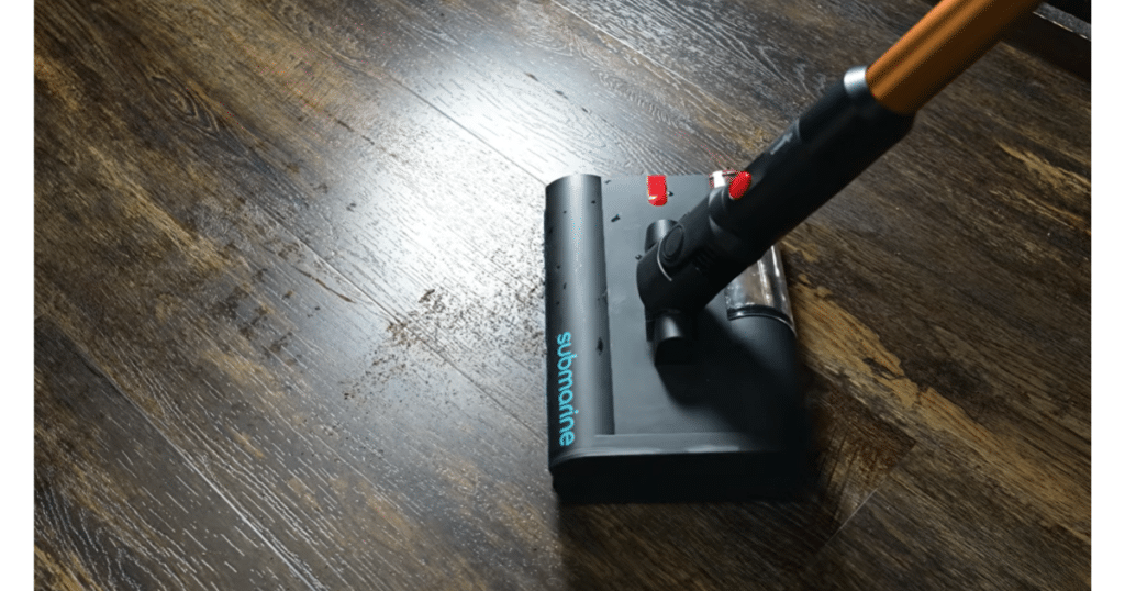 Dyson V16 Piston Animal Submarine Head Debris Pickup Vacuum Wars | Vacuum Wars Dyson V16 Submarine wet-cleaning head pushing loose debris across a hard floor during mopping.