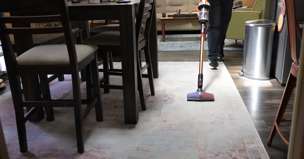 Dyson V16 Piston Animal Submarine Vacuuming Carpet Vacuum Wars | Vacuum Wars Dyson V16 Piston Animal Submarine cleaning a large area rug in a home setting.