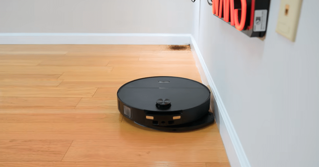 Roborock Saros 20 Sonic mop extend | Vacuum Wars Roborock Saros 20 Sonic extending its vibrating mop pad to clean along a wall edge.