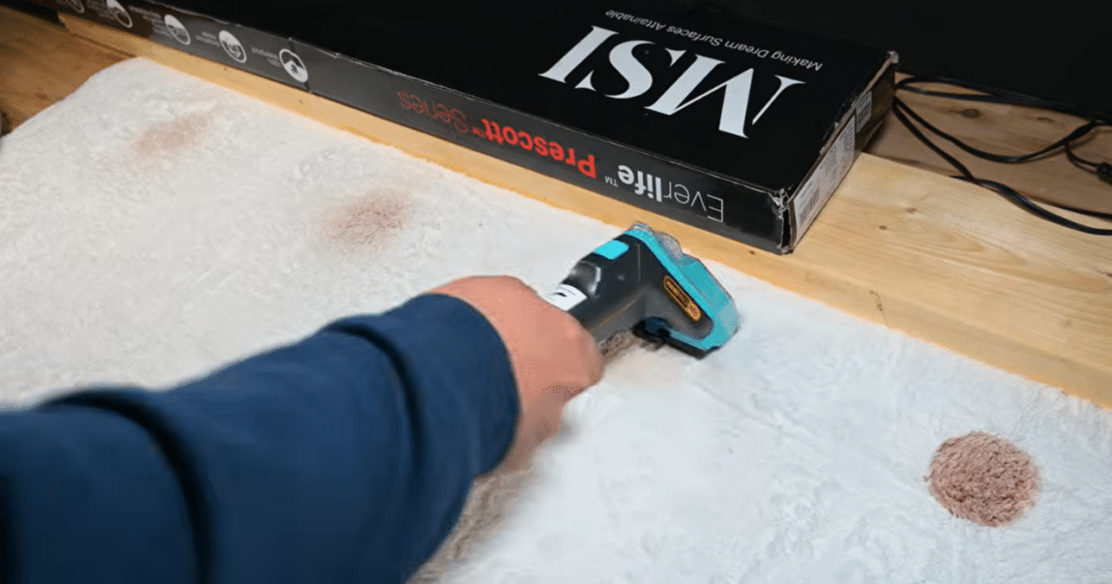 Shark StainStriker Spot clean | Vacuum Wars Shark StainStriker HairPro applying cleaning solution to a carpet stain during Vacuum Wars spot-cleaning tests.