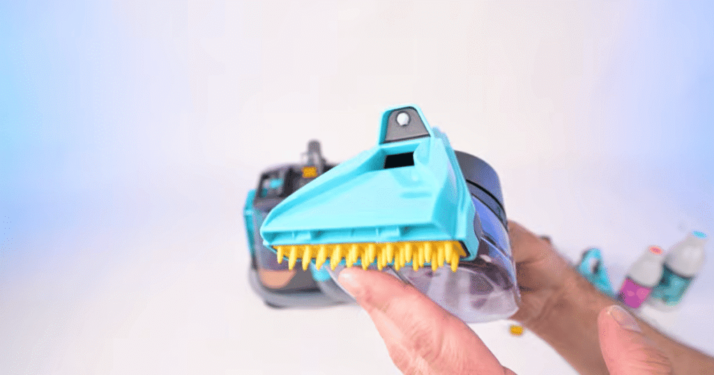 Shark StainStriker extractor tool | Vacuum Wars Close-up of the Shark StainStriker HairPro HairPro extractor tool during Vacuum Wars testing. The attachment uses an internal hair cage to funnel and capture hair, helping reduce clogs caused by pet hair and carpet fibers.