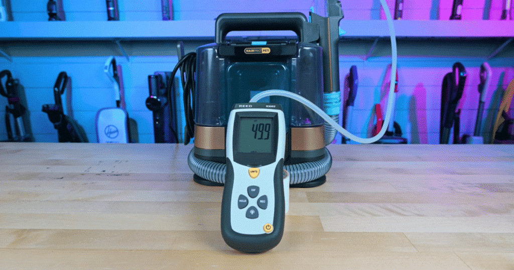 Shark StainStriker suction | Vacuum Wars Shark StainStriker HairPro undergoing suction testing during Vacuum Wars evaluation. The unit measured 13.1 kPa of internal suction versus the 12.7 kPa category average and 50.4 inches of water lift at the hose versus the 54-inch average.