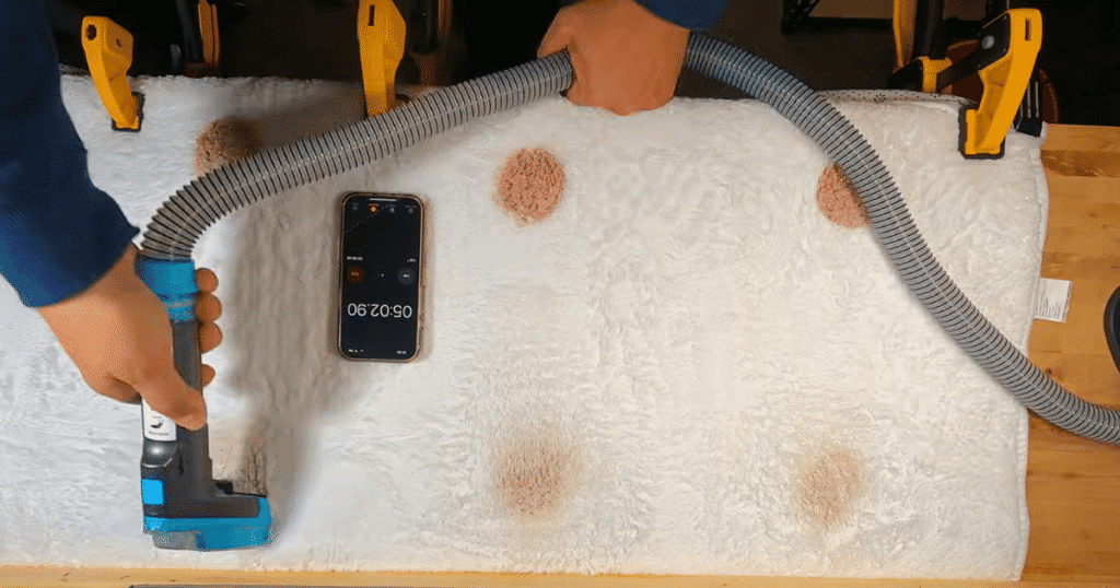 Shark StainStriker use 1 | Vacuum Wars Shark StainStriker HairPro cleaning dried grape juice stains from white carpet during the Vacuum Wars stain reduction test.