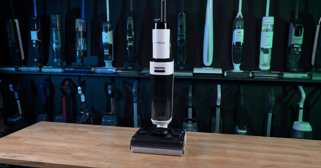 Tineco Floor ONE Stretch 6 wet dry vacuum at Vacuum Wars | Vacuum Wars Tineco Floor ONE Stretch S6 hard floor cleaner displayed in the Vacuum Wars studio with other floor care products in the background.