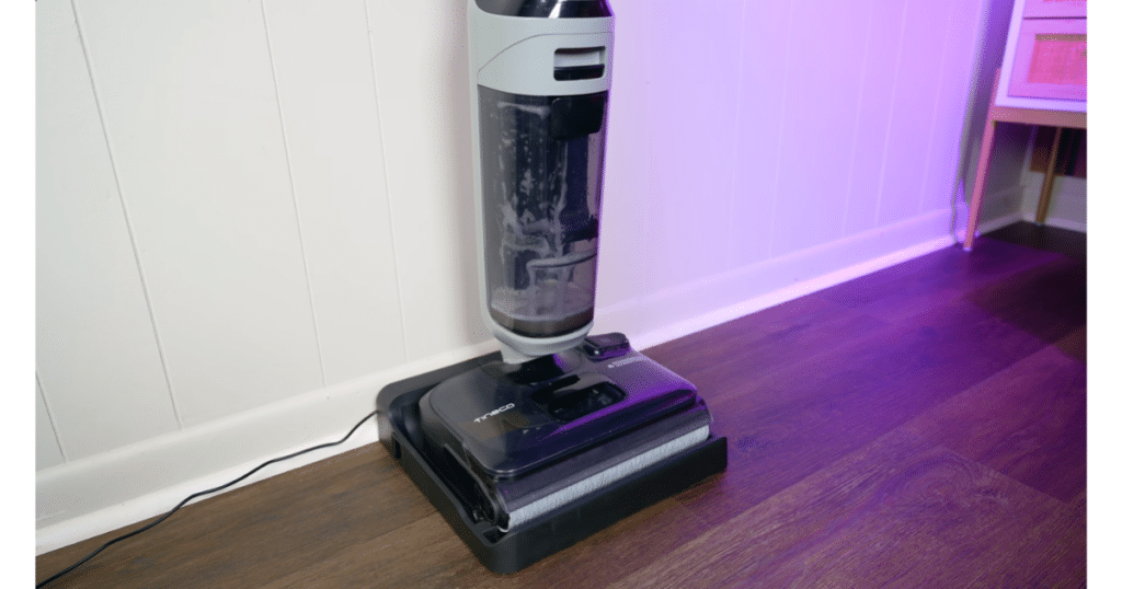 Tineco Floor One i5 Stretch Docked Self Cleaning Vacuum Wars | Vacuum Wars Tineco Floor One i5 Stretch standing on its charging base during the automated self-cleaning cycle.