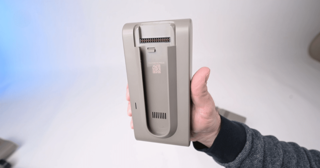 Detachable Battery Score Cordless Vacuums at Vacuum Wars | Vacuum Wars Hand holding a removable cordless vacuum battery to demonstrate a detachable battery design.