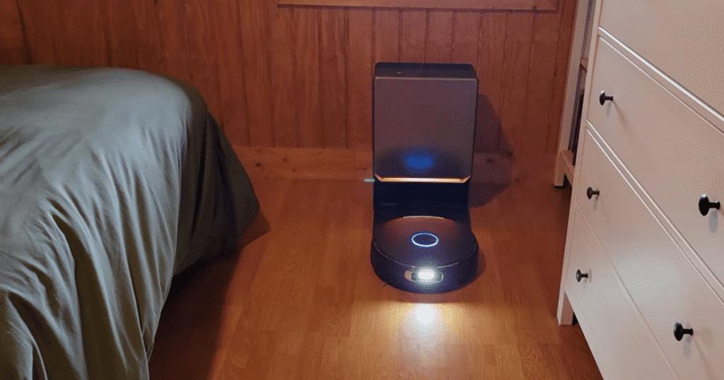 Narwal Flow 2 Home dock | Vacuum Wars Narwal Flow 2 robot vacuum docked at its narrow auto-empty base station with accent lighting in a bedroom.
