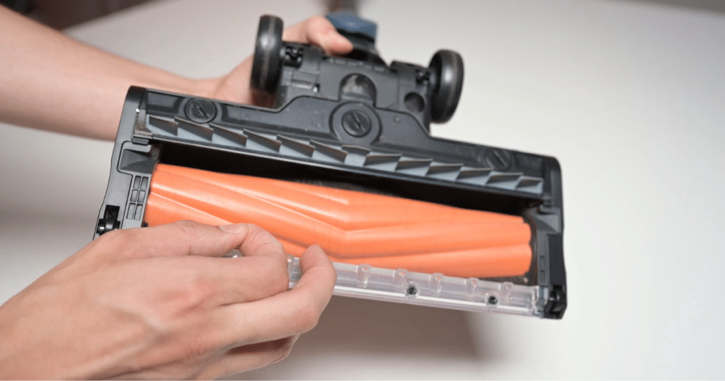 Removing hair tangled around a cordless vacuums brushroll | Vacuum Wars Vacuum Wars inspecting a cordless vacuum brush roll after the 14-inch human hair tangle test.