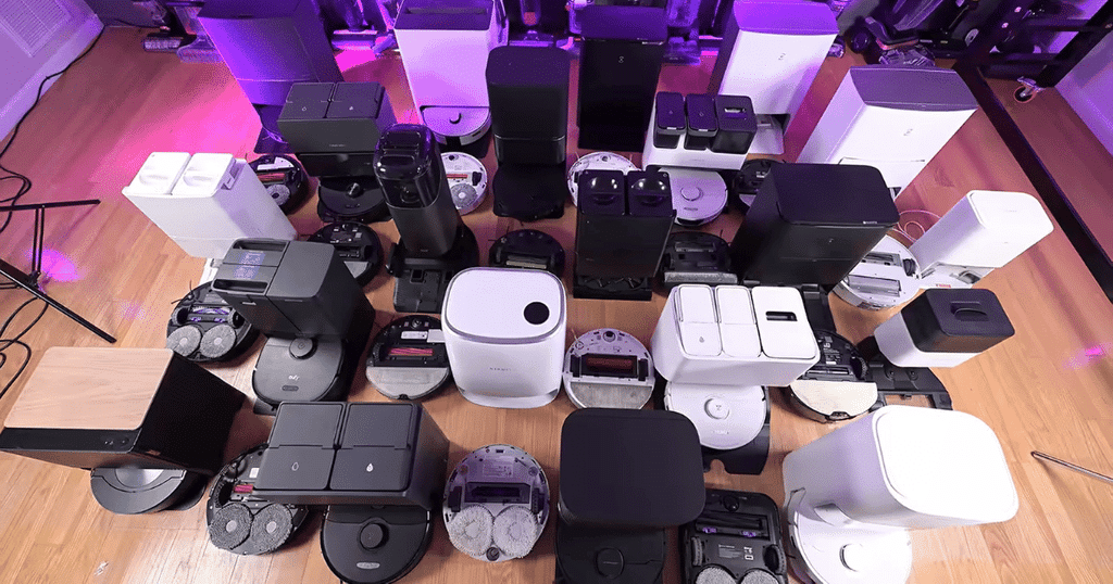 Robot buyer guide robots studio | Vacuum Wars Collection of robot vacuums and self-cleaning docks in the Vacuum Wars testing studio, showing a wide range of designs and features.
