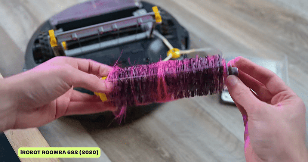 Robot buyer guide tangle | Vacuum Wars Long hair wrapped around a robot vacuum’s bristled brush roll during a Vacuum Wars hair-tangle test.