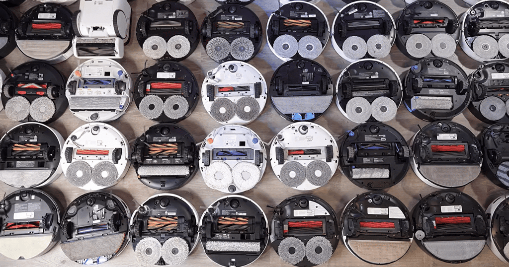 Robot buyer guide undersides | Vacuum Wars Undersides of multiple robot vacuums showing different main brushes, side brushes, mop systems, and floorhead designs.