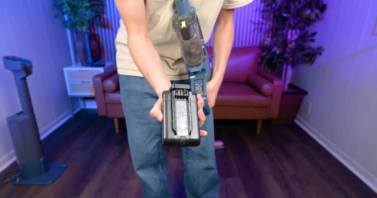 Shark-PowerDetect-Speed-Review-battery | Vacuum Wars A person showing the detachable battery of the Shark PowerDetect Speed cordless vacuum.