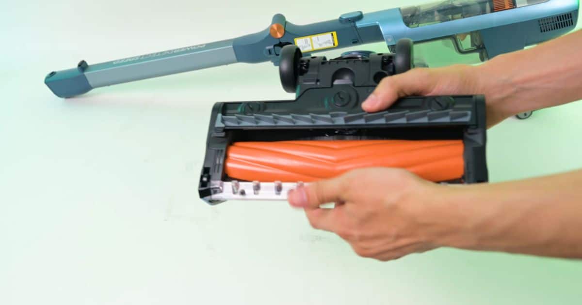 | Vacuum Wars Underside of the Shark PowerDetect Speed floorhead showing its single orange brushroll and larger front openings for debris pickup.
