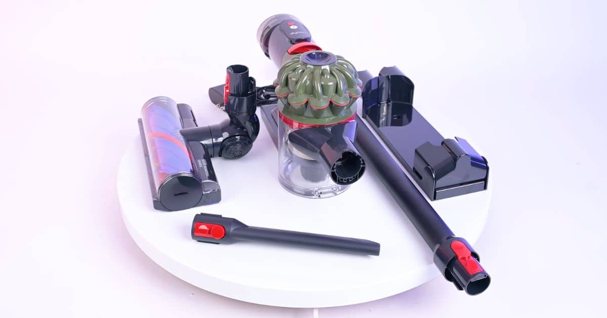 | Vacuum Wars Dyson V8 Cyclone components including the vacuum body, Motorbar cleaner head, wand, wall mount, and included crevice tool.