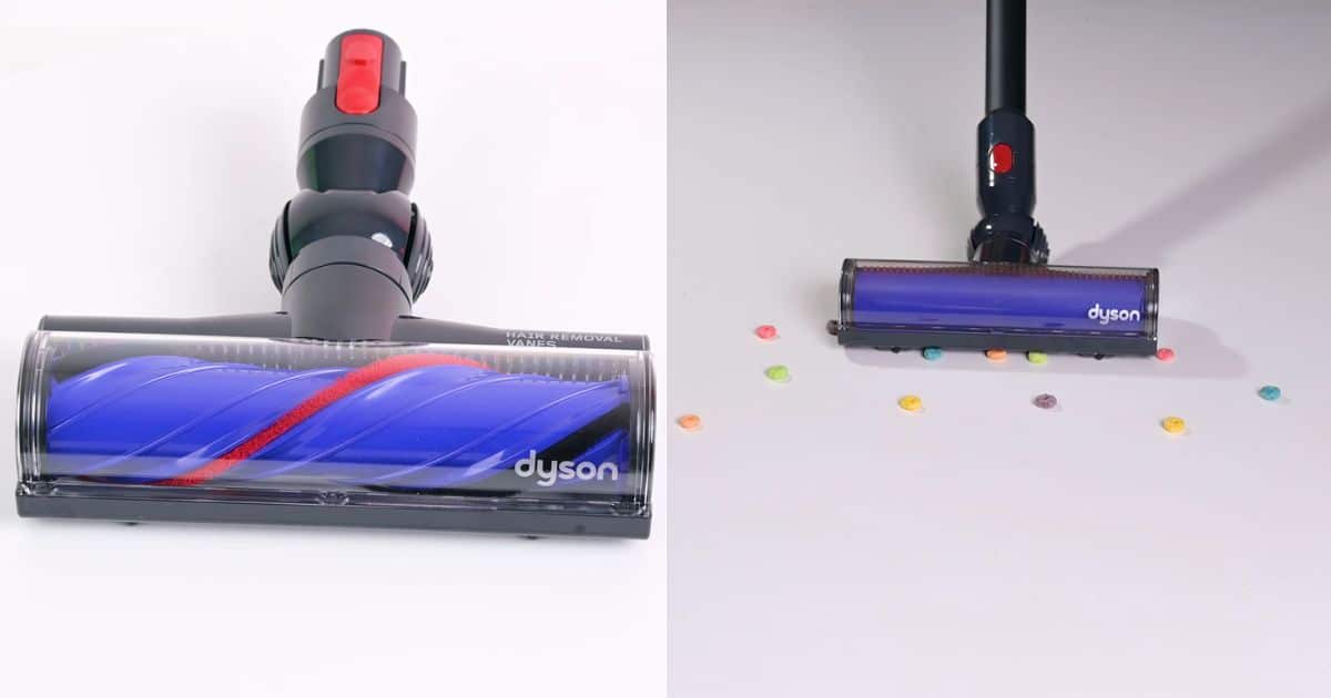 | Vacuum Wars Close-up of the Dyson V8 Cyclone Motorbar cleaner head with hair-removal vanes, shown picking up debris on a hard floor.