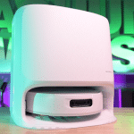 Narwal Freo 20 in studio 150 | Vacuum Wars Small white compact device with rounded edges, front USB-C port, on a wooden surface.
