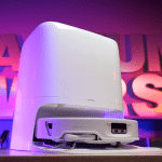 Roborock Qrevo Edge 3 Pro in studio 150 | Vacuum Wars Compact white projector on a small stand, bathed in purple ambient lighting in the background.