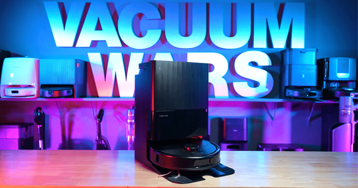 | Vacuum Wars Roborock Qrevo S Pro robot vacuum and multifunction dock displayed on a table at the Vacuum Wars studio.