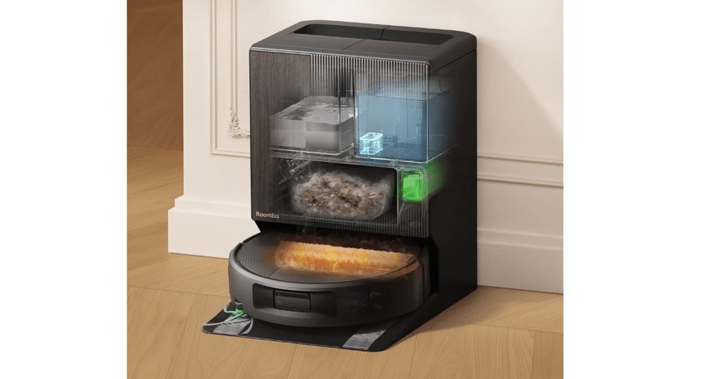 iRobot Roomba Max 875 Combo Dock | Vacuum Wars Cutaway rendering of the Roomba Max 875 at its AutoWash Dock, showing the internal water tanks, debris bag, and roller-cleaning system.