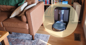 Ecovacs X12 at Home Vacuum Wars Review | Vacuum Wars Robot vacuum cleaner moving on a wooden floor beside a brown leather sofa in a living room.