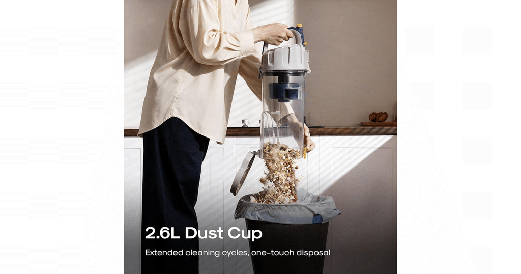 Eureka PowerSpeed E2 upright vacuum dust cup being emptied into a trash bin.
