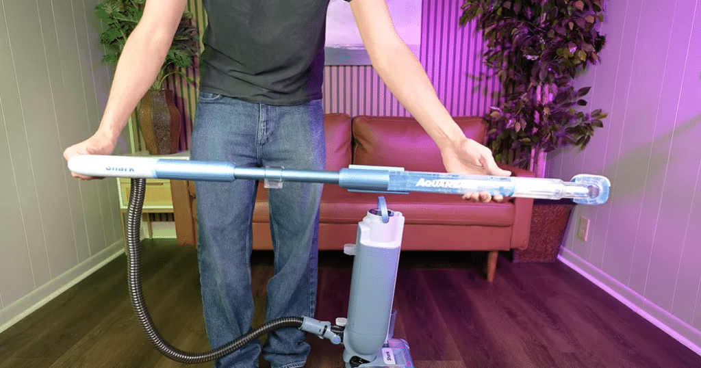 Shark AquaReach Wet Dry Vacuum Stick Mode at Vacuum Wars | Vacuum Wars Shark AquaReach’s removable cleaning wand held horizontally in its extended position, with the hose connected to the cleaner.