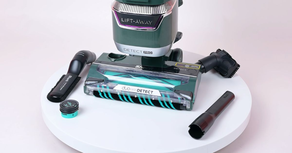 | Vacuum Wars Shark Detect Pro LA802 shown with its crevice tool, dusting brush, pet multi-tool, floorhead, and odor neutralizer cartridge.