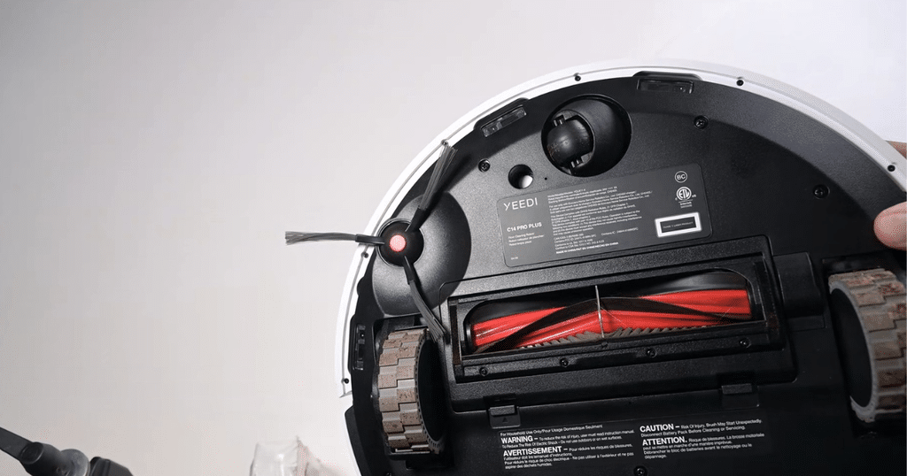 Yeedi C14 PRO Plus robot vacuum hair tangle test | Vacuum Wars Robot vacuum interior exposed: red brush roller and drive wheels visible inside the device labeled YEEDI C14 PRO PLUS