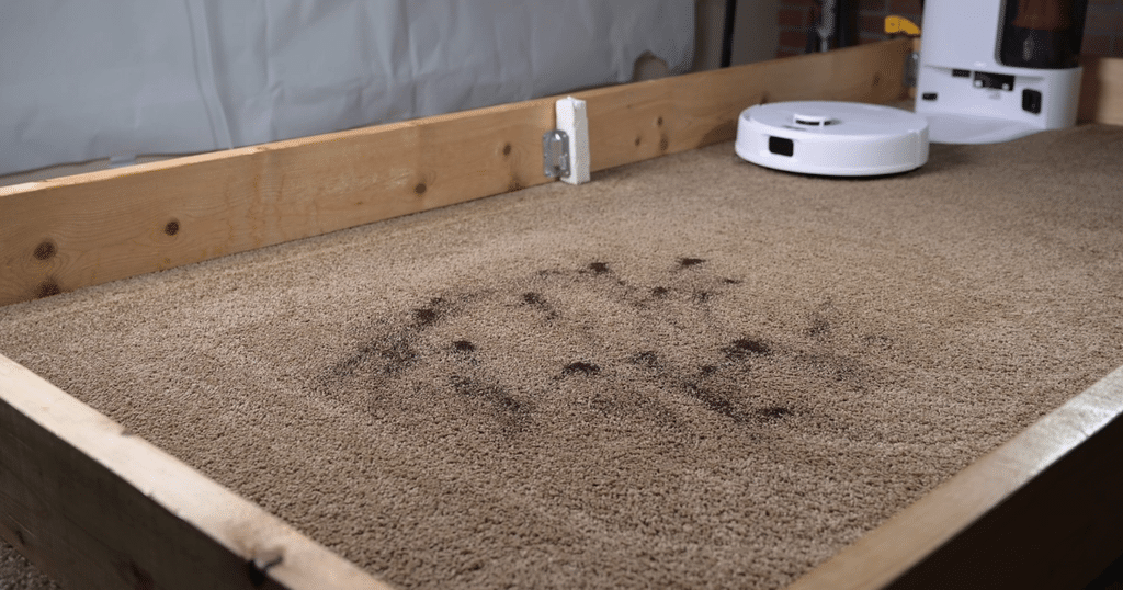 Yeedi C14 PRO Plus roboto vacuum carpet deep clean test 1 | Vacuum Wars Yeedi C14 Pro Plus robot vacuum approaching fine debris on a carpet in the Vacuum Wars studio.